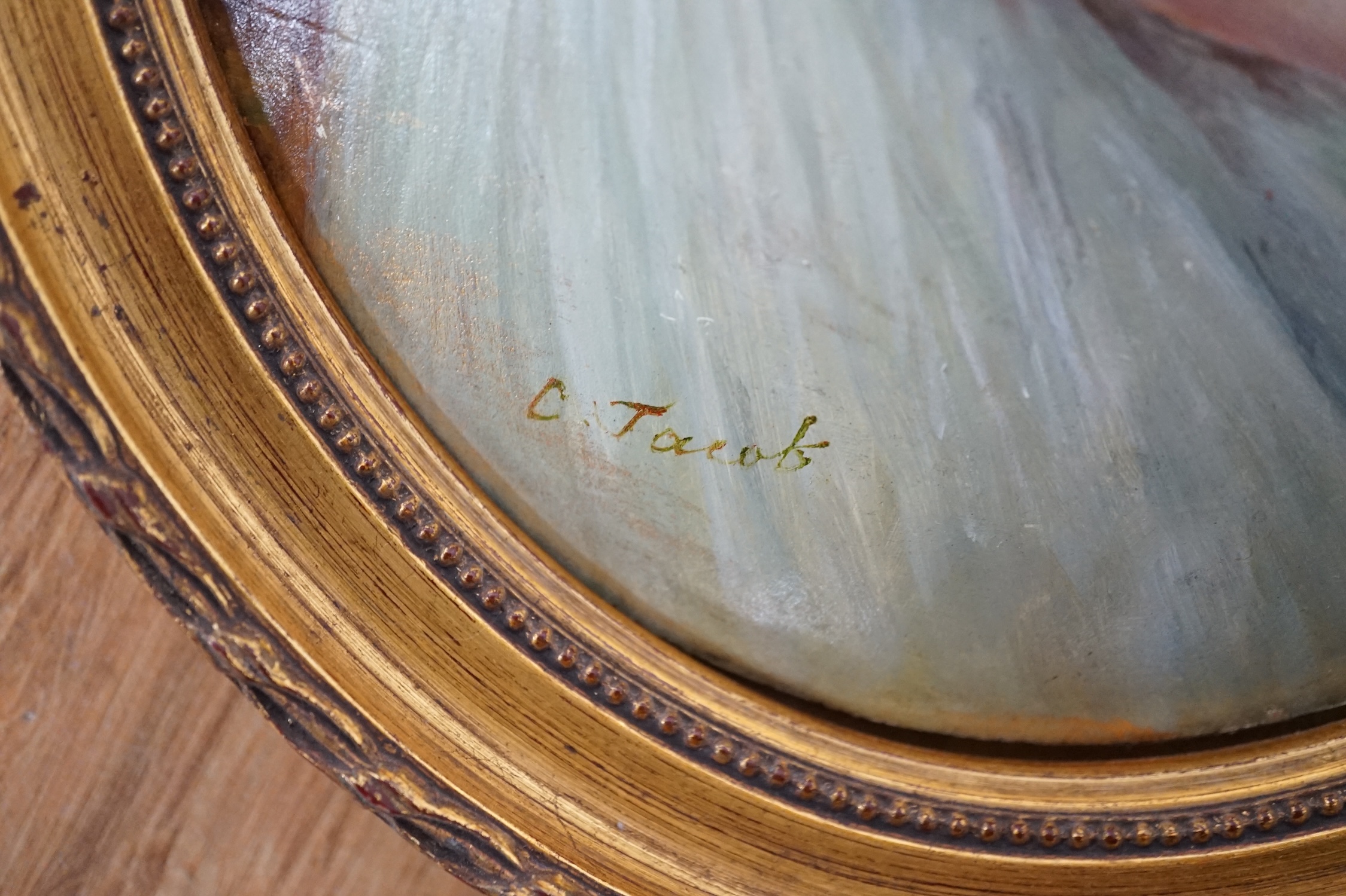 F. Jacob, oval oil on moulded composition, Study of a young lady with a dog, signed, 24 x 19cm, gilt frame. Condition - fair to good
